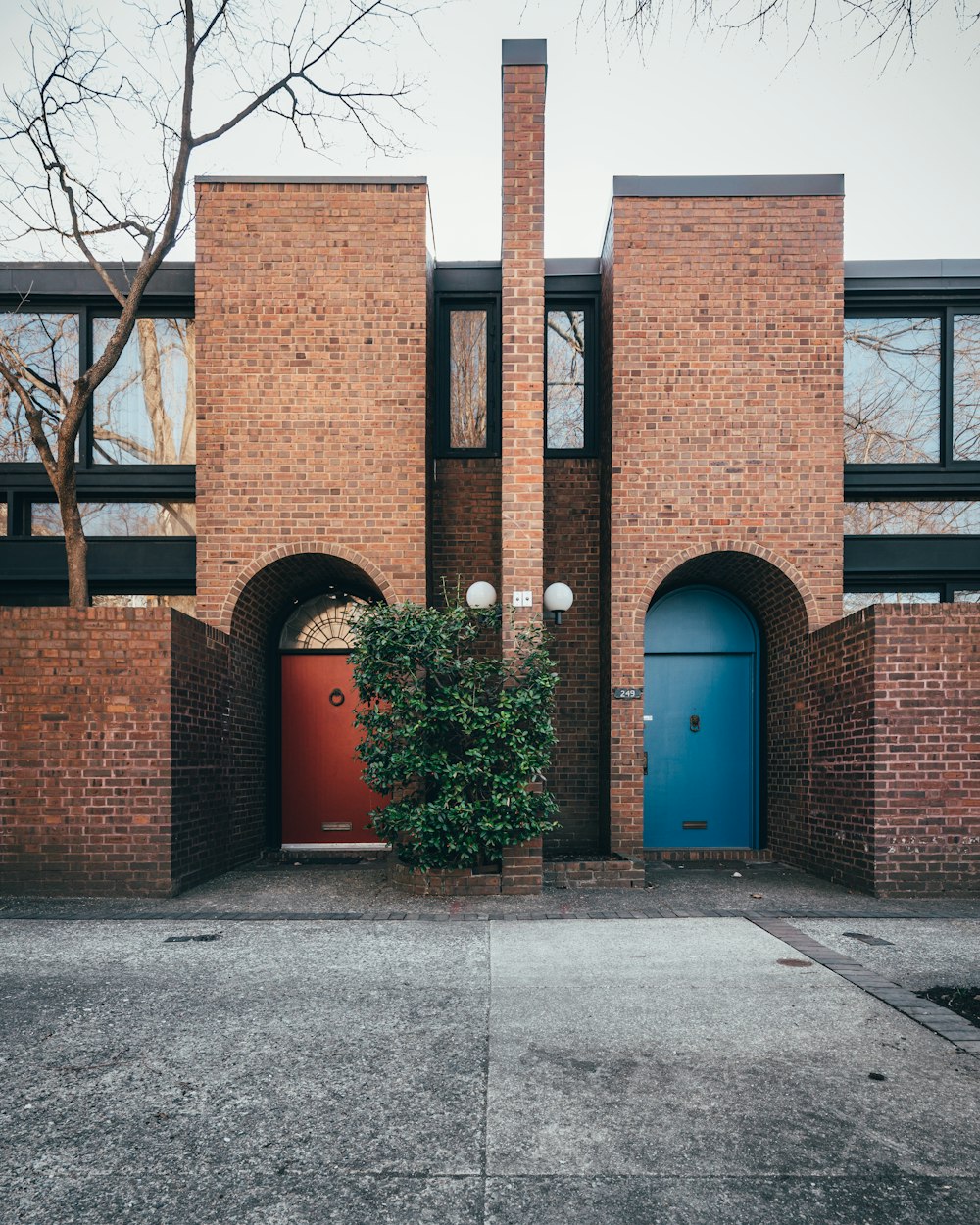 brown concrete building near bare trees during daytime