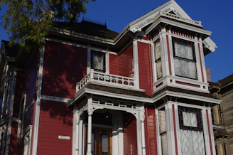 Before and after shots of a charming Victorian house restored with fresh paint and updated windows.