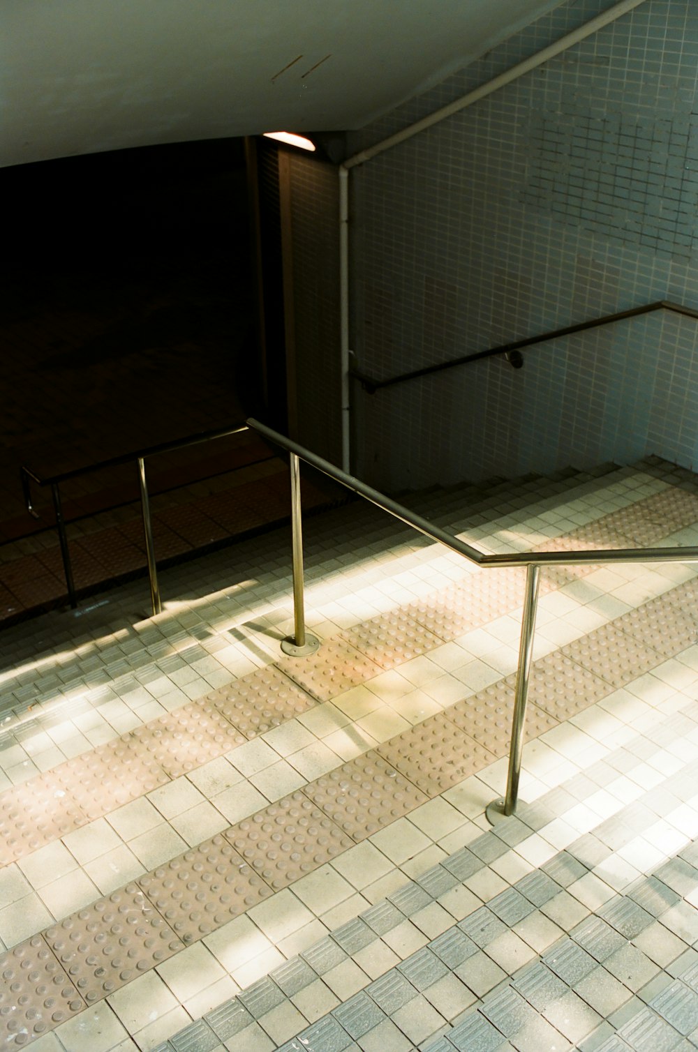 stainless steel railings on white ceramic tiles