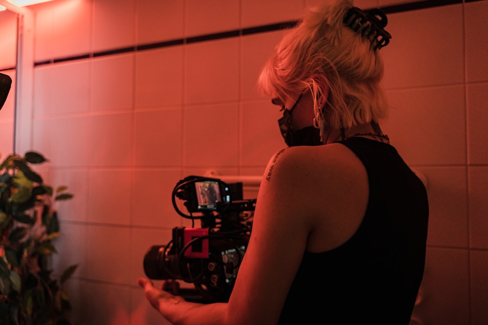 woman in black tank top standing in front of black gas stove