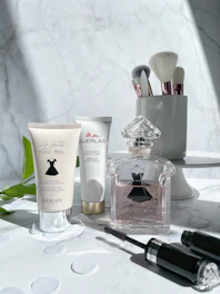 Beauty accessories arranged neatly on a white marble countertop