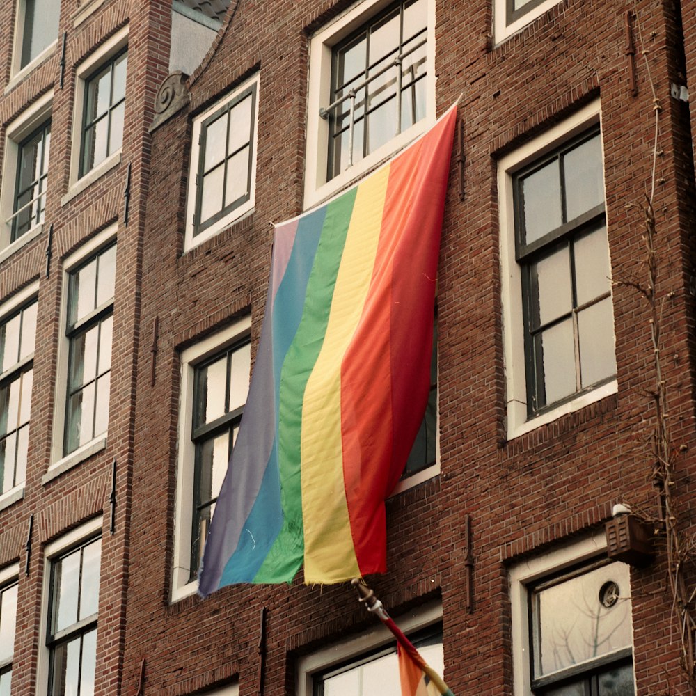 multi colored flag on brown concrete building