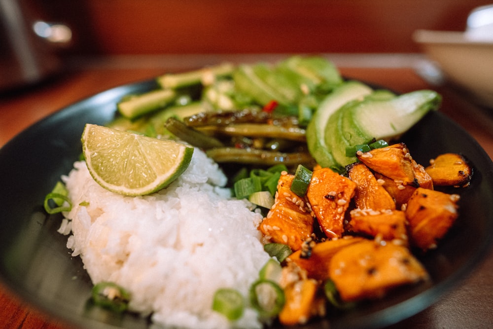 sliced carrots and green vegetable on white ceramic plate