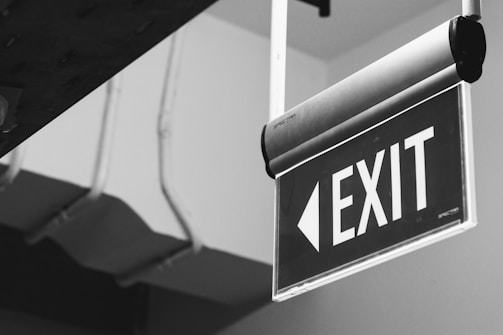 grayscale photo of a black and white arrow sign