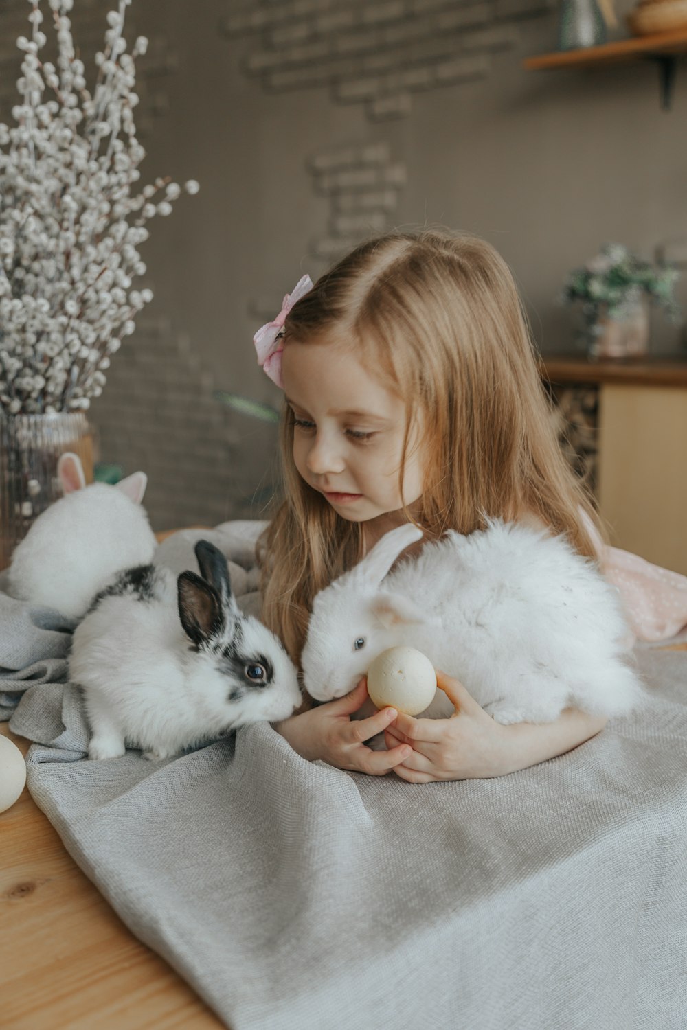 girl in white fur jacket holding white rabbit