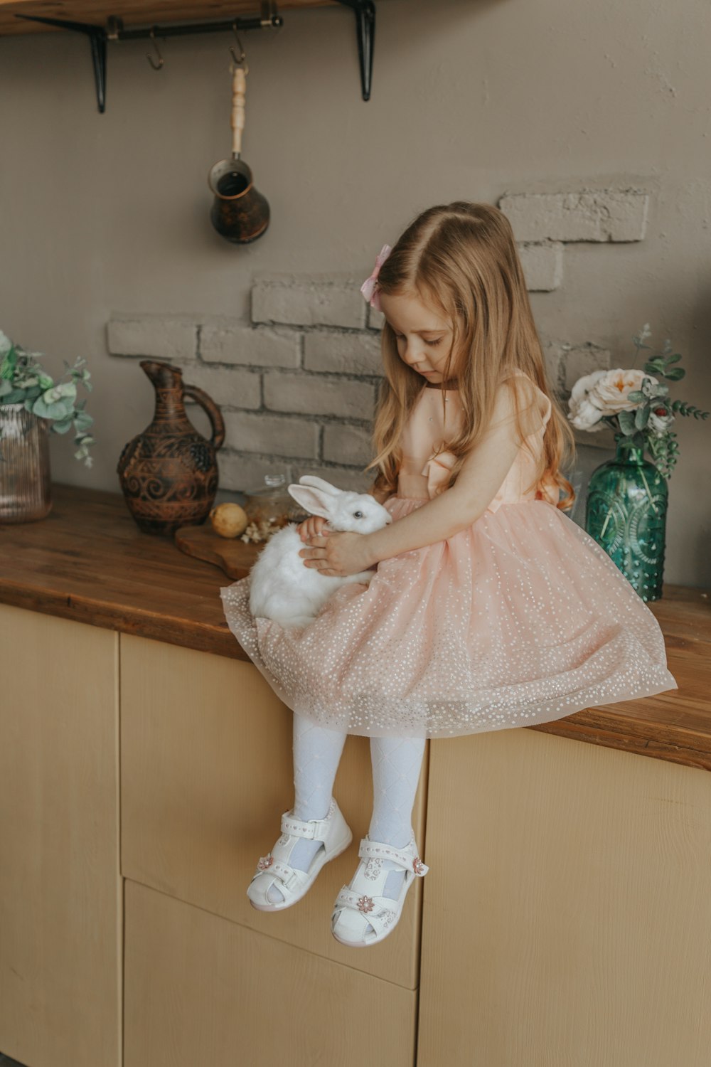 mujer en vestido rosa sosteniendo juguete de peluche de conejo blanco