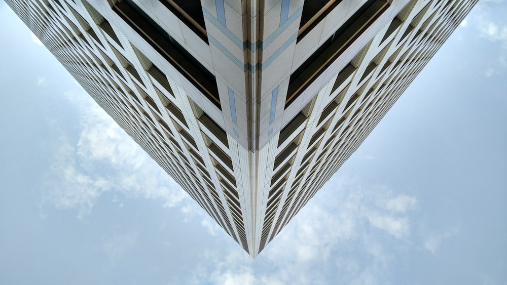 white and black concrete building under white clouds during daytime