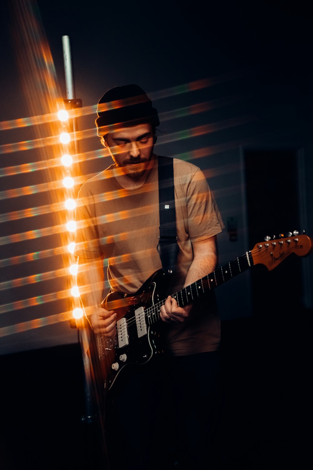 man in white dress shirt playing electric guitar