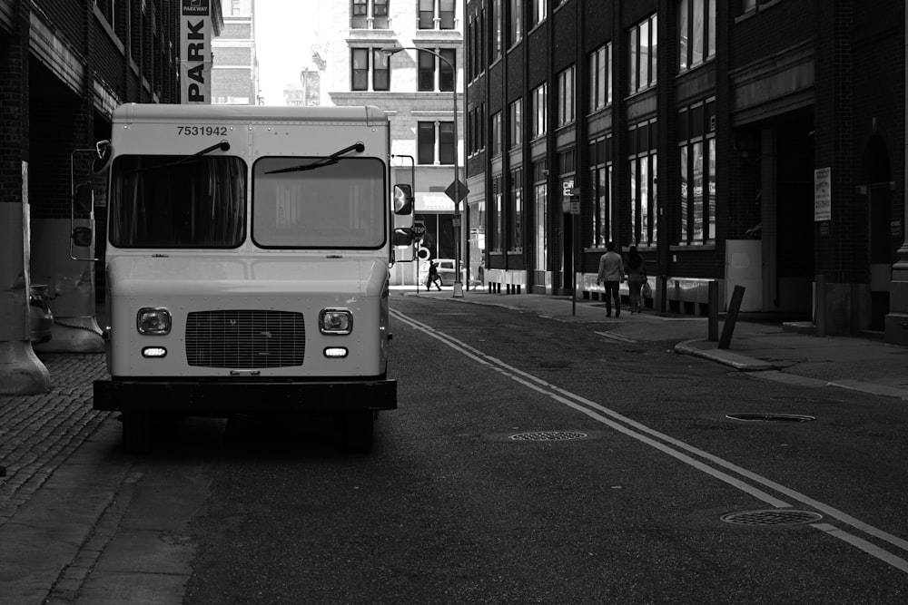 grayscale photo of bus on road