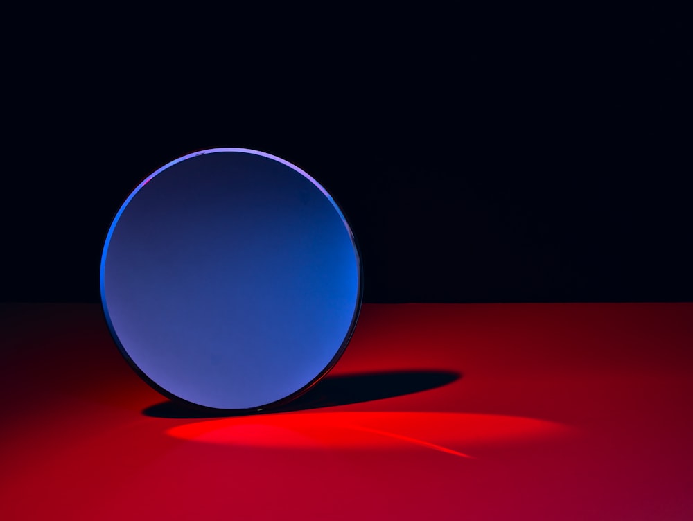 blue round ball on red textile