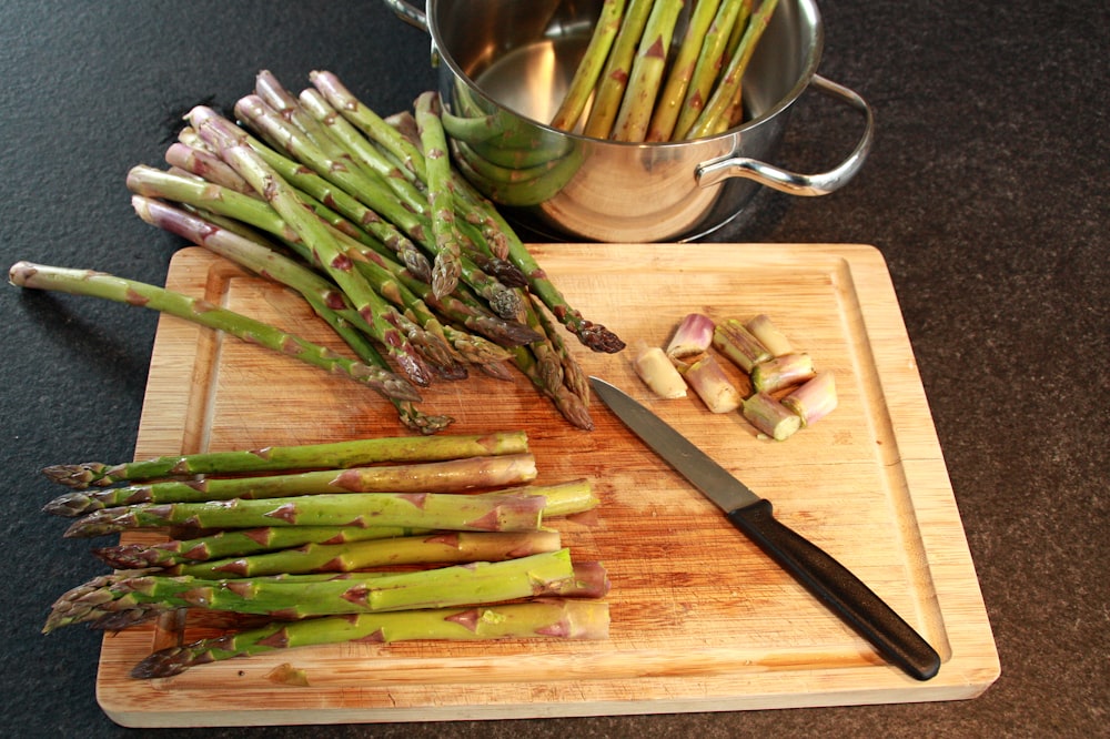 green vegetable on brown wooden chopping board