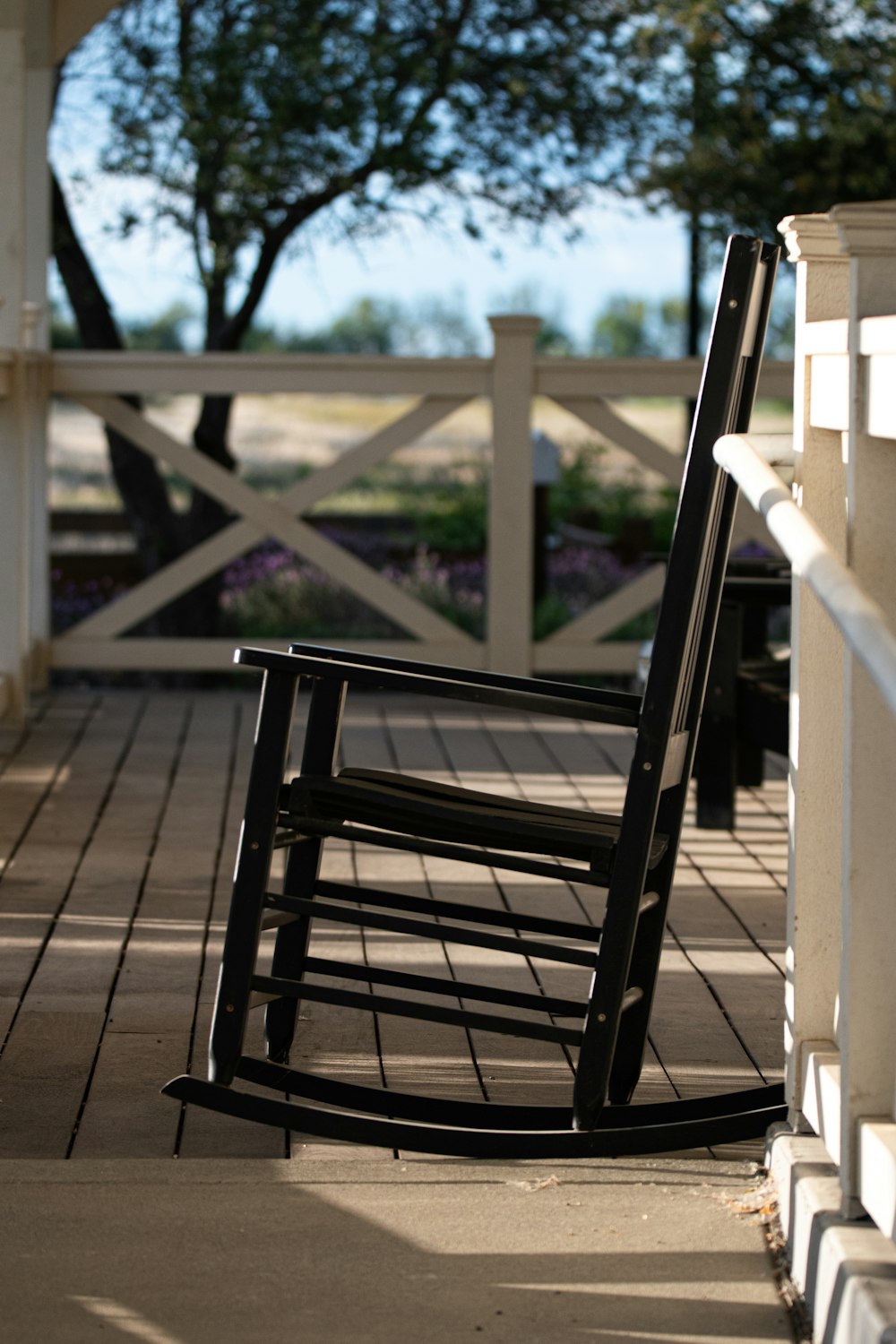 brown wooden rocking chair on brown wooden deck during daytime
