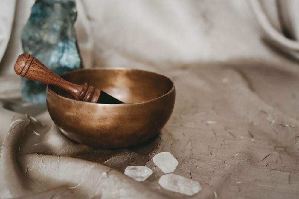 brown wooden bowl on white textile