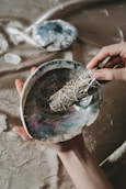 person holding blue and brown paint