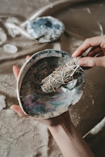 person holding blue and brown paint