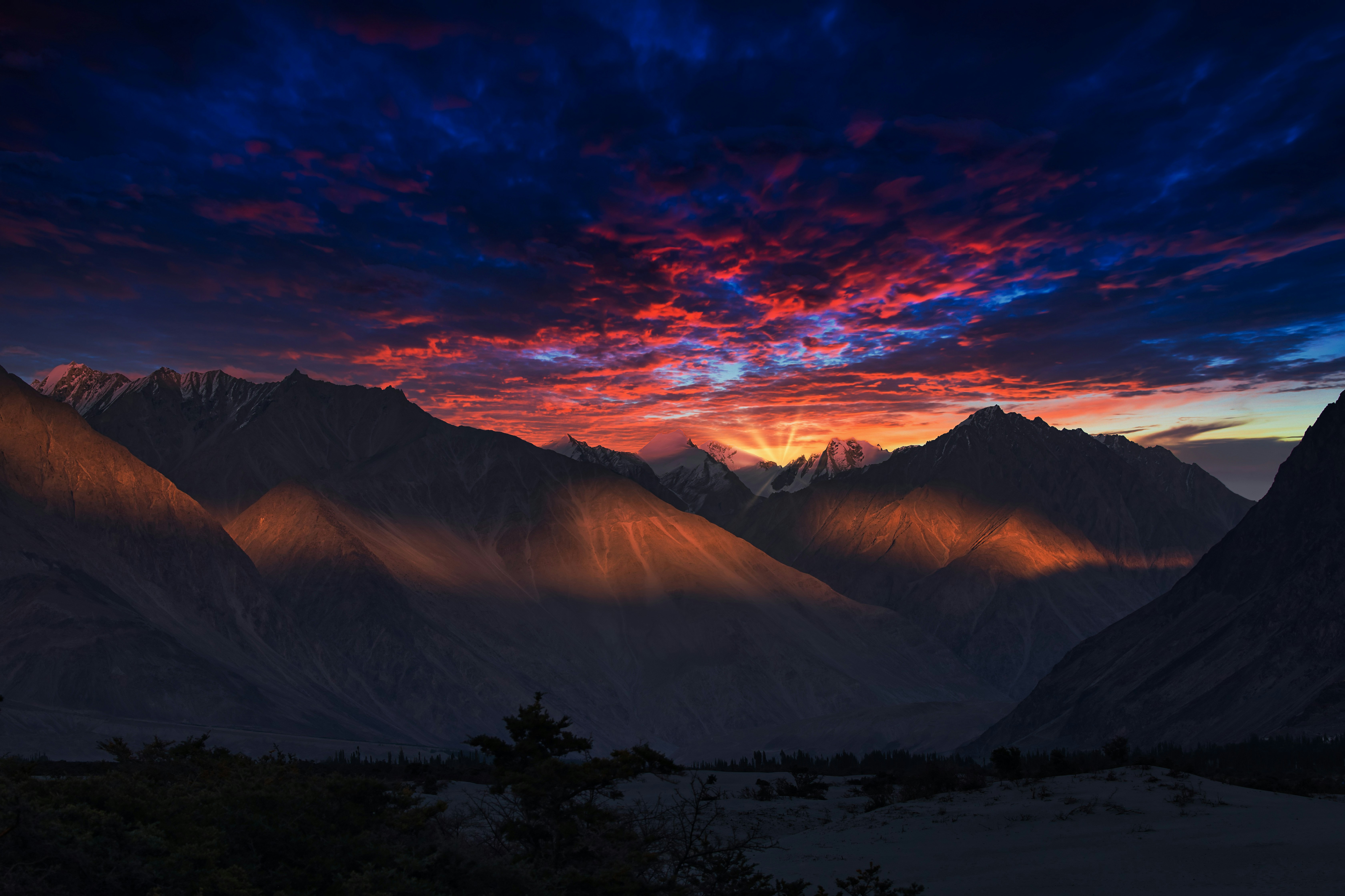 snow covered mountains during sunset