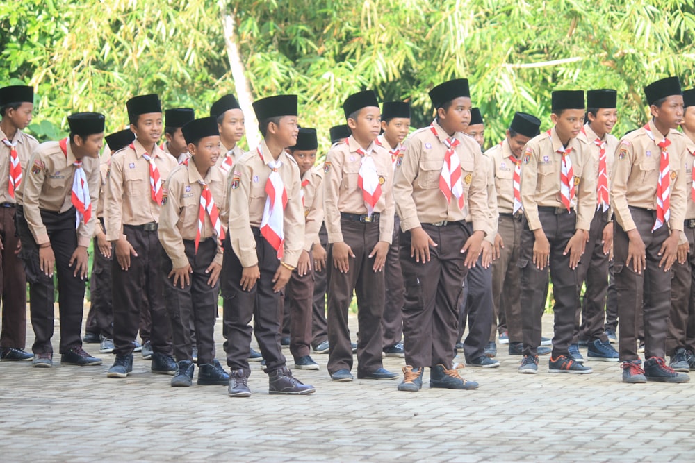 group of men in white uniform standing on gray concrete floor during daytime