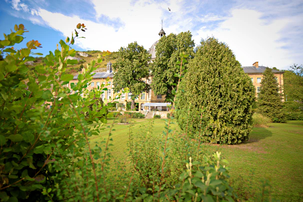 Historic university building with classic architecture surrounded by lush greenery.