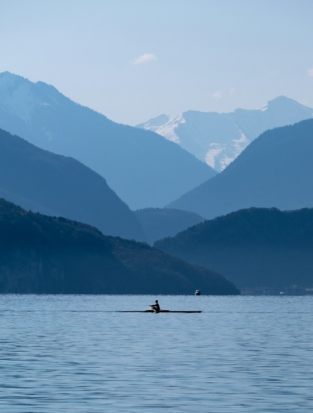 person riding on boat on lake during daytime