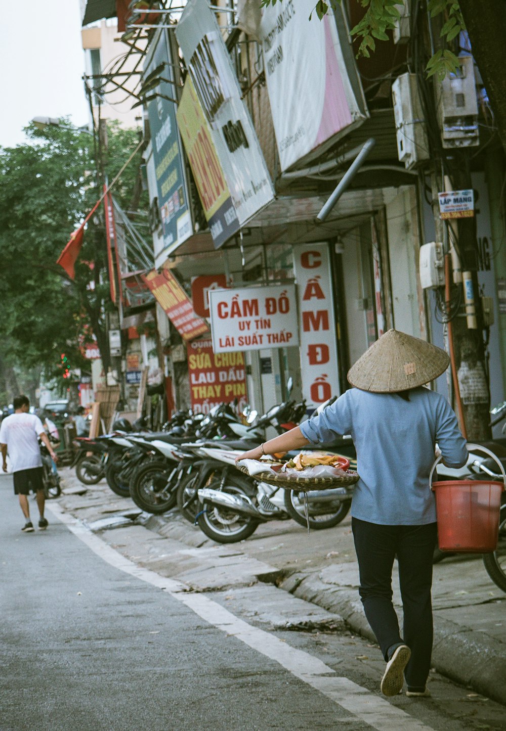 man in brown hat and white shirt riding on motorcycle during daytime