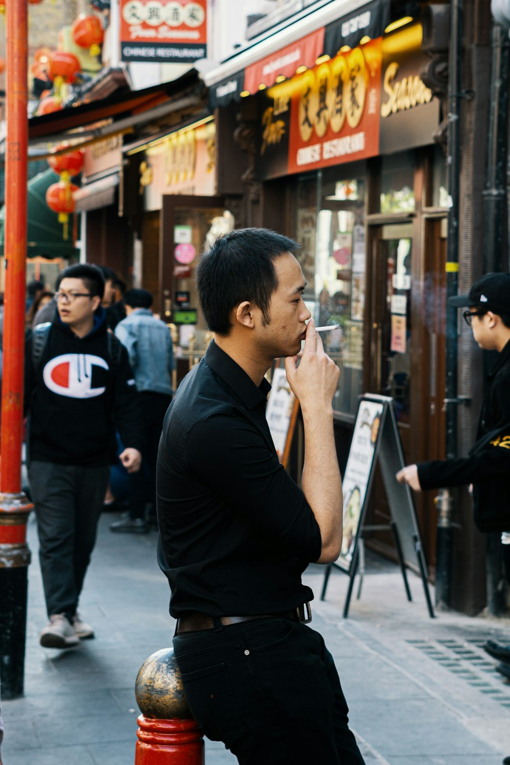 man in black long sleeve shirt holding smartphone