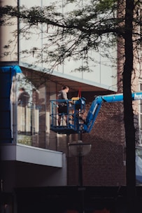 A professional cherry picker lifting workers safely to a building facade in Van.