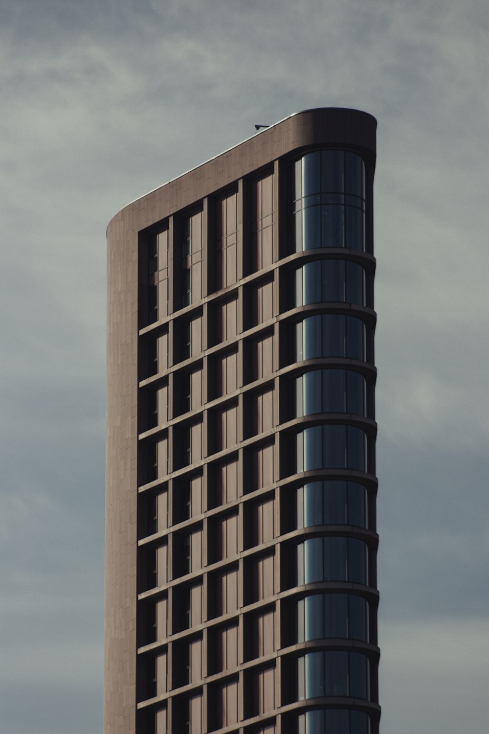 brown concrete building under cloudy sky during daytime