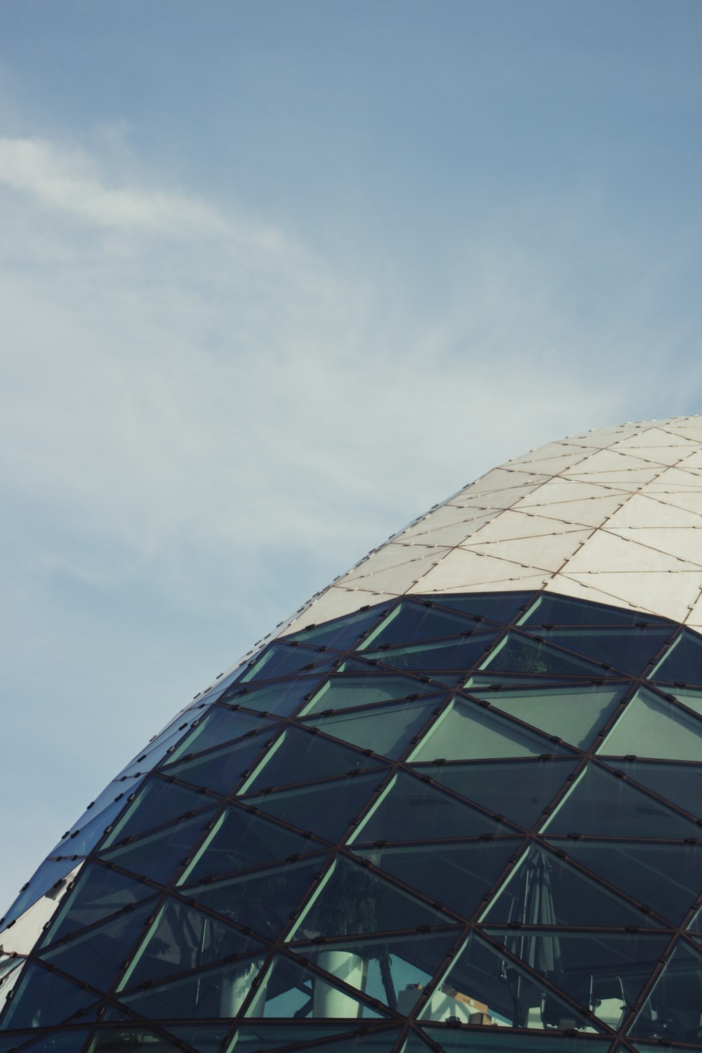 gray and black round building under white clouds during daytime