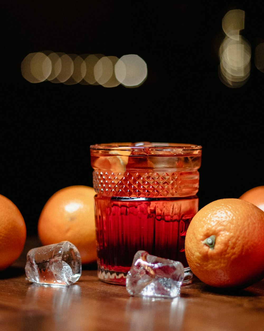 orange fruit beside clear drinking glass