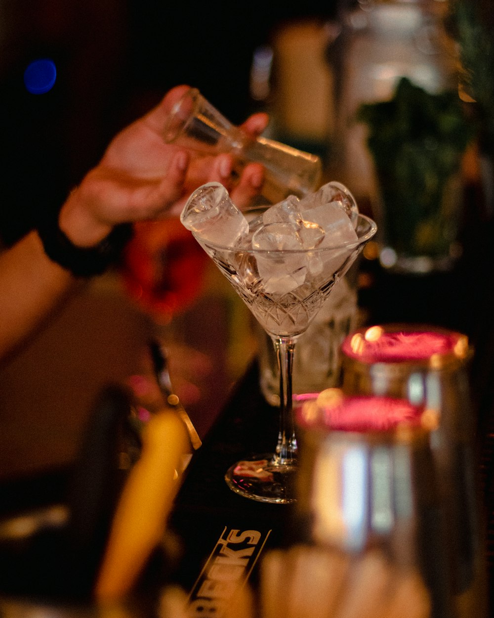 person holding clear glass bowl with ice