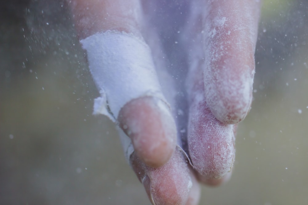 persons hand with white powder