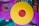 Two vinyl records are displayed, one in vibrant yellow with a red center and the other in vivid pink. The records rest atop a collection of album covers featuring various artistic designs and text, including the words 'Enter the Wu-Tang'.