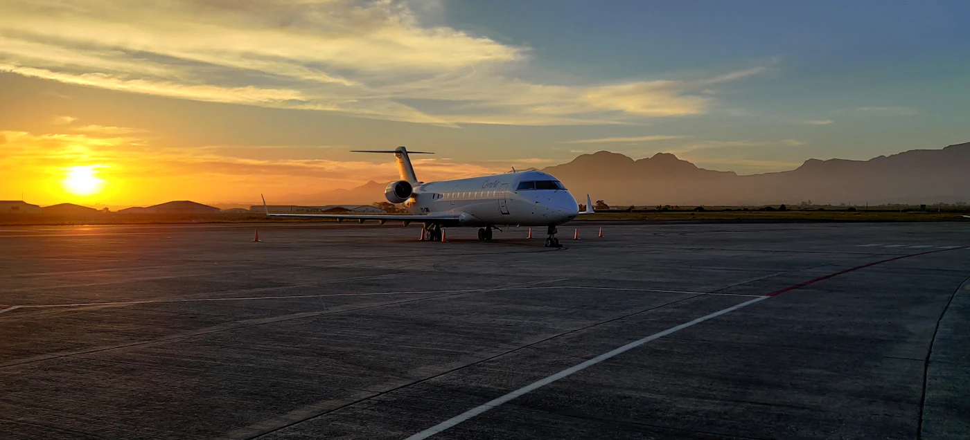 Private jet on the ramp in warm golden-hour light
