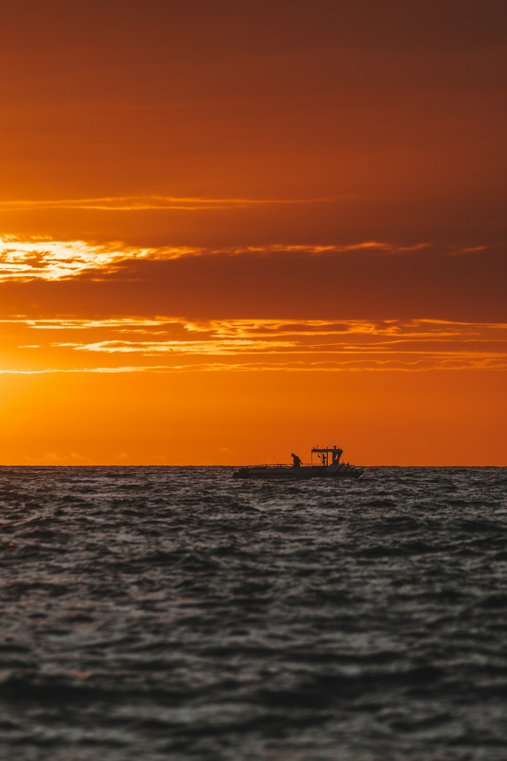 silhouette of people on boat during sunset