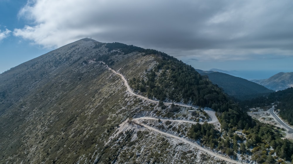 green and brown mountain under white clouds during daytime