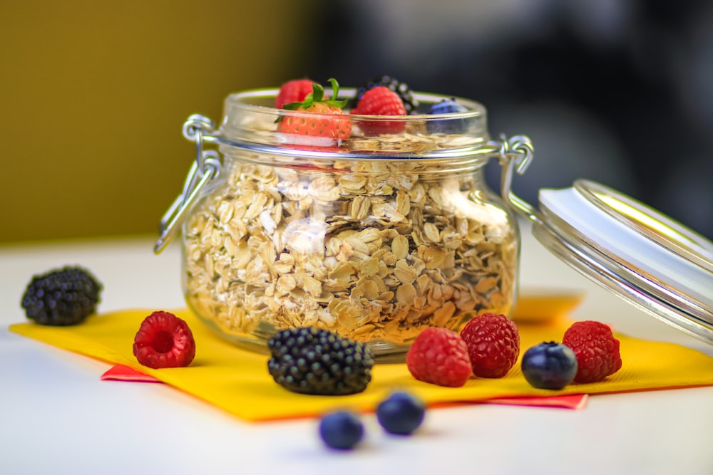 clear glass jar with black berries