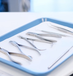 stainless steel fork and bread knife on white ceramic plate