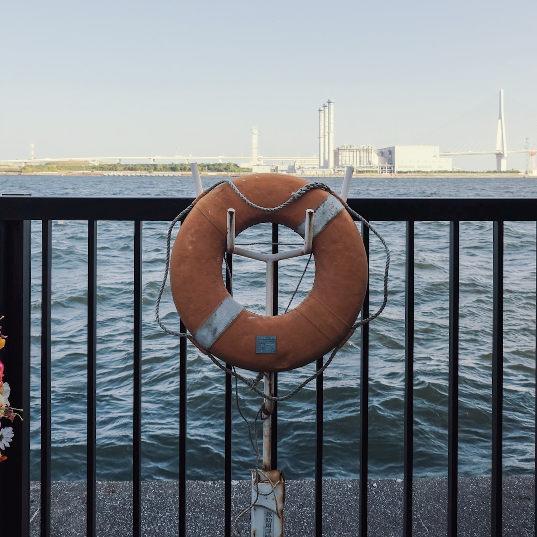 brown life buoy on black metal railings