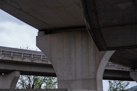 Close-up of sturdy concrete pillars and steel reinforcements at a construction site.