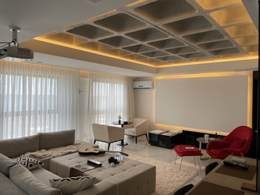 White and black sectional couch interior design solutions by Flats Noida