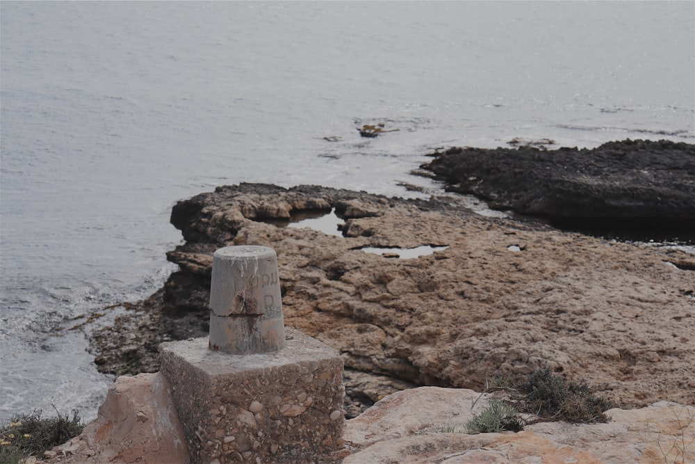 brown rock formation near body of water during daytime