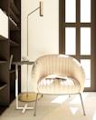 Close-up of a plush armchair beside a modern floor lamp in the city suite.