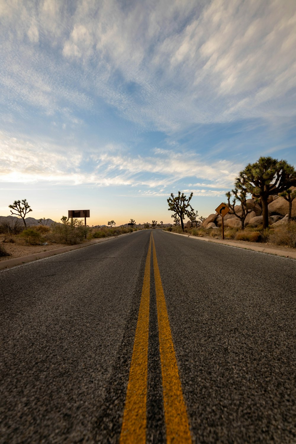 gray asphalt road under blue sky during daytime