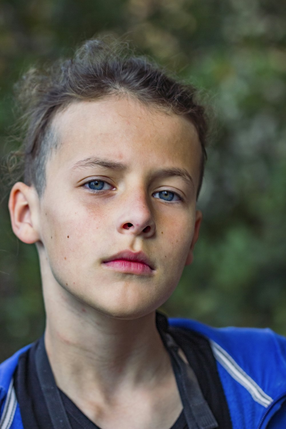 boy in blue and black hoodie