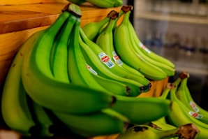 green banana fruit on brown wooden table