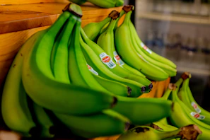 green banana fruit on brown wooden table