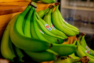 green banana fruit on brown wooden table