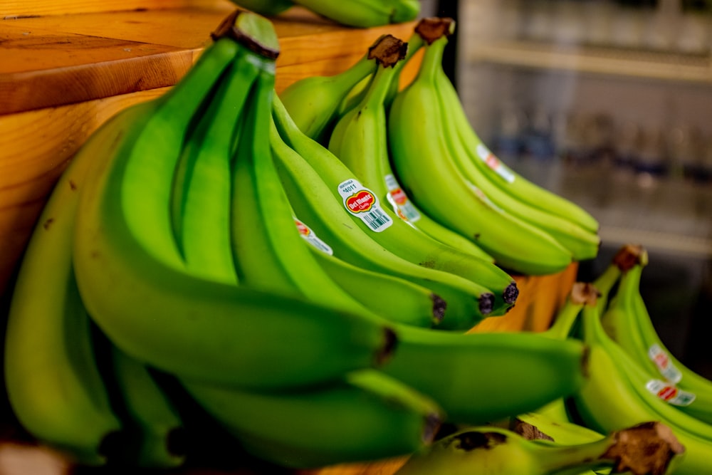 green banana fruit on brown wooden table