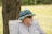 man in gray crew neck shirt wearing blue and white hat