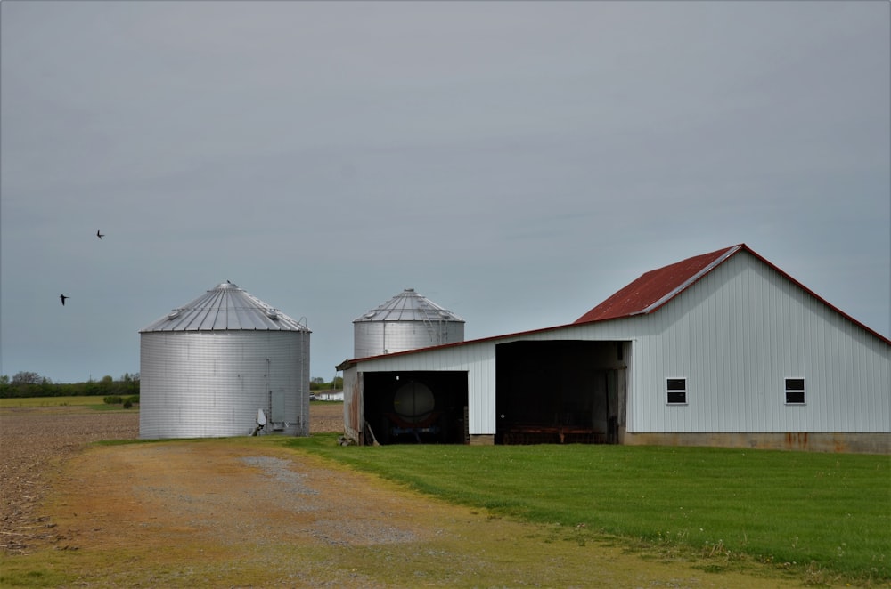 white and red barn house on green grass field under white sky during daytime